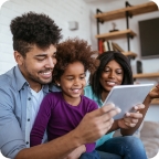 Parents use tablet with young daughter.